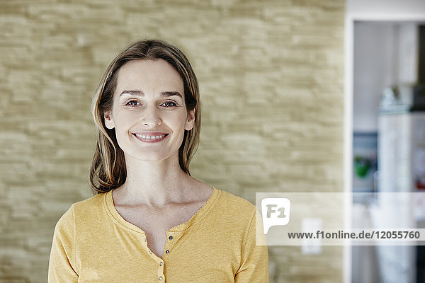 Portrait of smiling woman at home