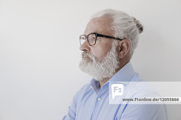 Portrait of serious mature man with beard and glasses