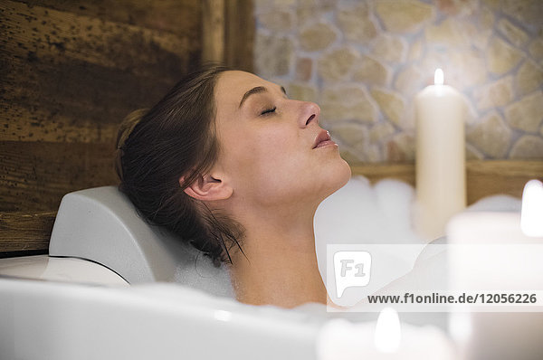 Woman taking a bath in candlelight