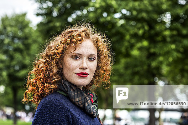 Portrait of redheaded young woman with red lips