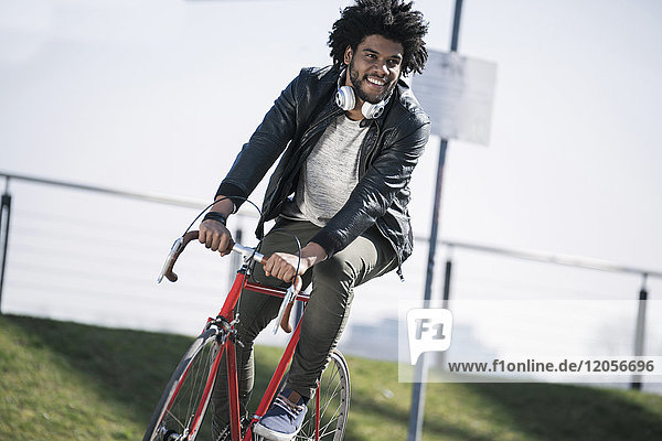 Smiling man riding bicycle