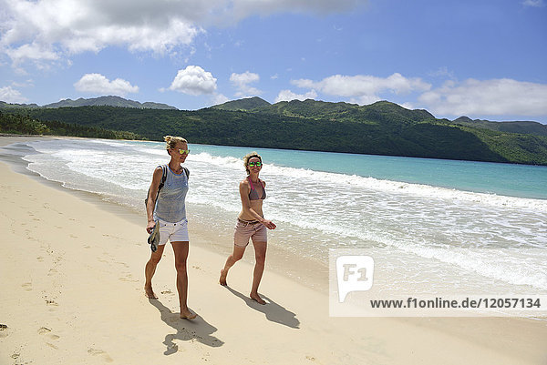 Dominican Republic  Samana  two women walking on the beach
