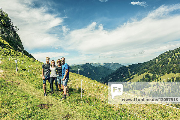 Germany  Bavaria  Pfronten  portrait of happy family on alpine meadow near Aggenstein