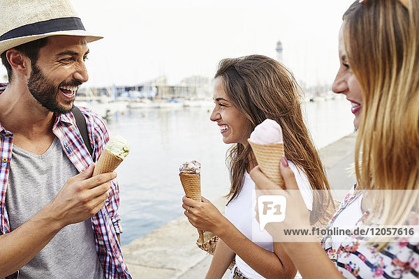 Three happy friends holding ice cream cones