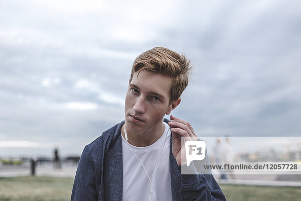 Portrait of young man with earphones