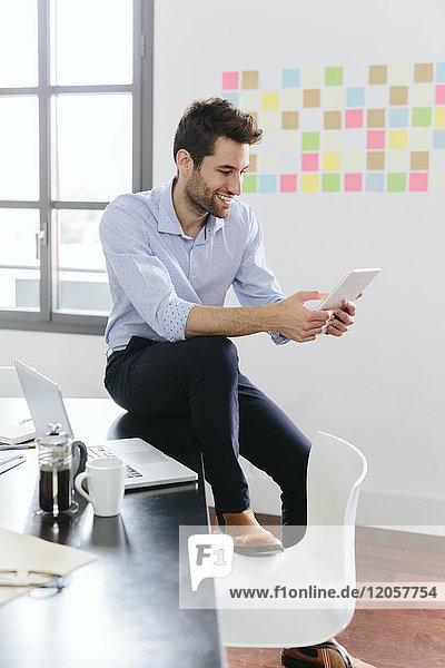Young businessman working in office  using smartphone