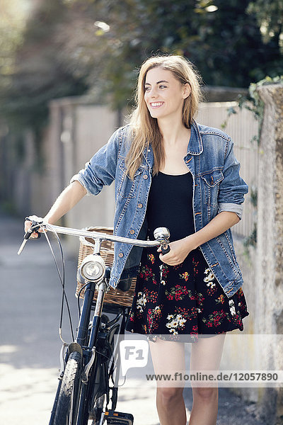 Young woan with bicycle in the city