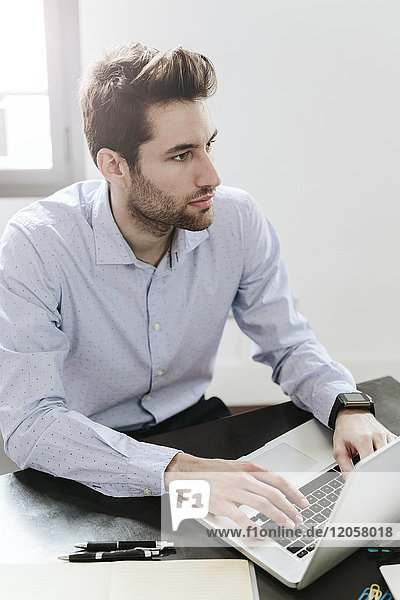 Young businessman working in office  using laptop