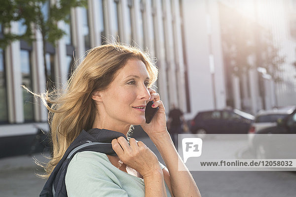 Portrait of woman on cell phone in the city
