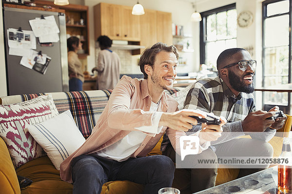 Men friends playing video game in living room
