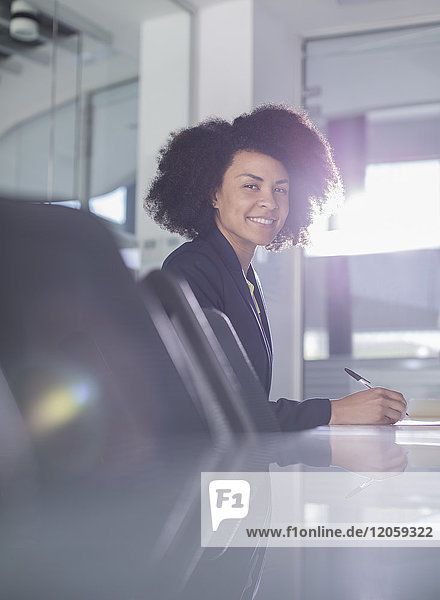 Portrait smiling businesswoman working in conference room