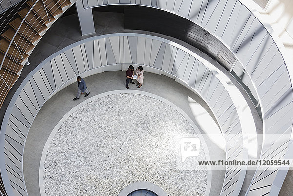 View from above business people talking in architectural  modern office atrium courtyard