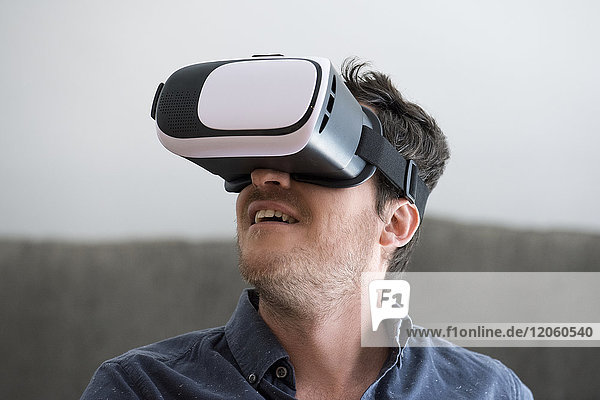 Mid adult man using virtual reality headset