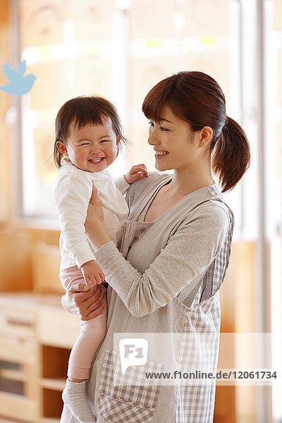 Teacher with kid at Japanese kindergarten