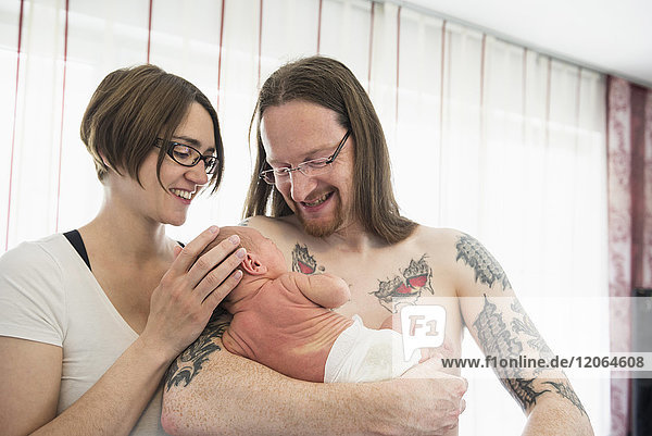 Happy parents holding their newborn baby