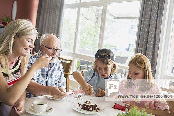 Family eating cake at rest home