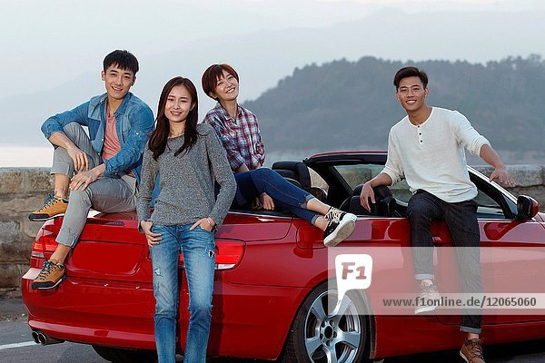 Young men and women travel by car