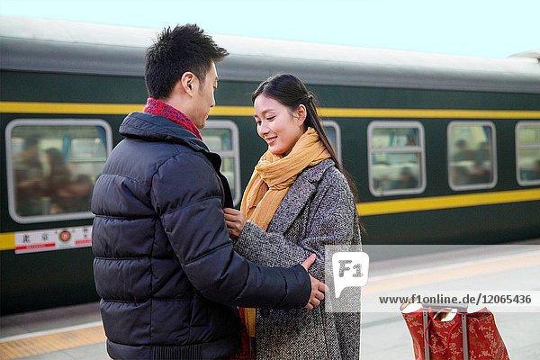 Young lovers at the railway station