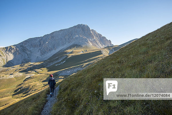 Hiker on the path to the summit of peak Corno Grande  Gran Sasso e Monti della Laga National Park  Abruzzo  Italy  Europe