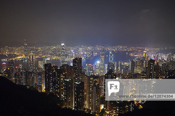 View at night of central Hong Kong and Victoria Harbour from Victoria Peak  looking toward Kowloon in background  Hong Kong  China  Asia