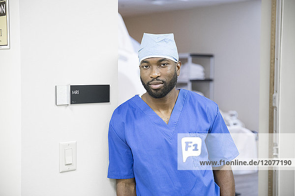Portrait of confident black nurse near MRI sign
