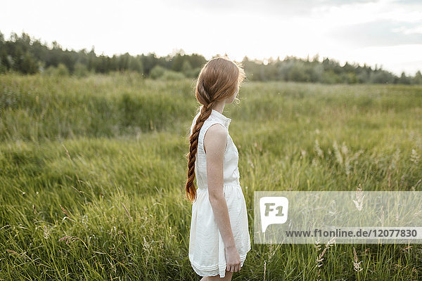 Caucasian girl standing in field