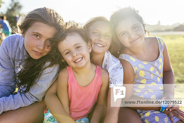 Group picture of four girls head to head at backlight