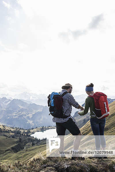 Germany  Bavaria  Oberstdorf  two hikers with map in alpine scenery