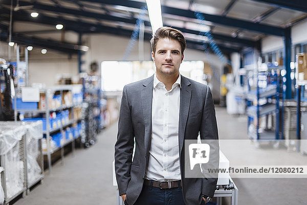Young manager standing in shop floor  portrait
