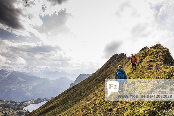 Germany  Bavaria  Oberstdorf  two hikers walking on mountain ridge