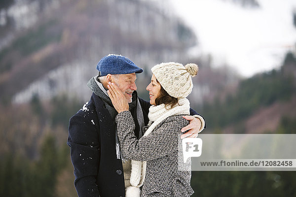 Happy senior couple in winter landscape