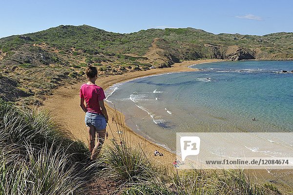 Young woman admiring the Cavalleria Beach at Cape Cavalleria on the North Coast of Menorca  Balearic Islands  Spain  Europe.