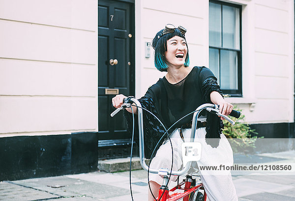 Junge stilvolle Frau mit Retro-Fahrrad auf der Straße