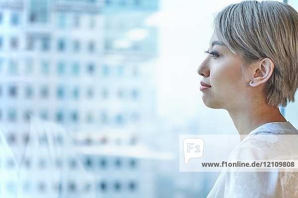 Portrait of businesswoman looking out of window