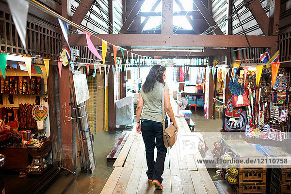 Rückansicht einer Frau  die durch den Markt geht  Bangkok  Krung Thep  Thailand  Asien