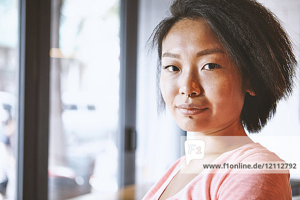 Portrait of woman with nose piercing in cafe  Shanghai French Concession  Shanghai  China