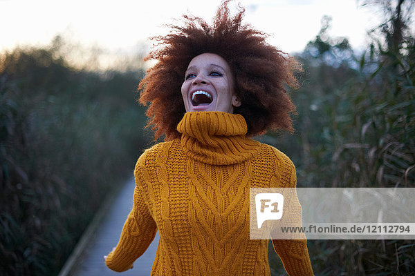 Portrait of young woman in rural setting  laughing