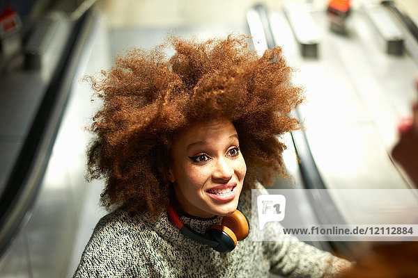 Young woman on escalator  smiling  elevated view