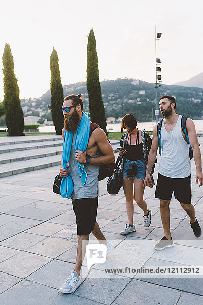 Three young hipster friends strolling on waterfront  Lake Como  Lombardy  Italy