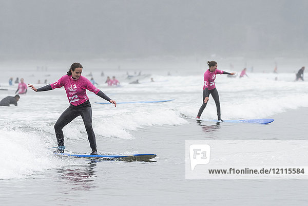 Girls learning to surf at Cox Bay Beach  Pacific Rim National Park  Vancouver Island; Tofino  British Columbia  Canada