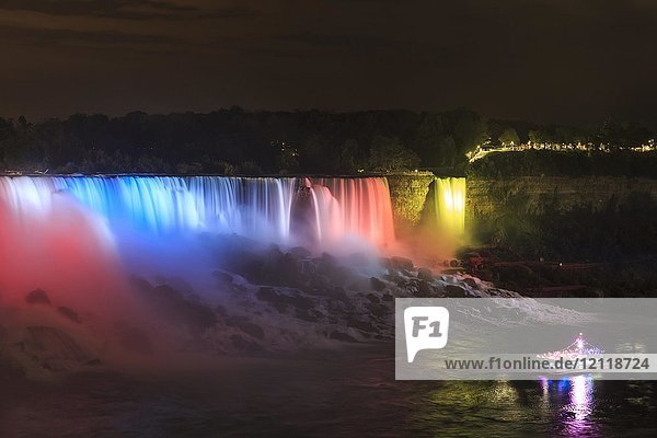 Tourist boat in front of illuminated waterfall  American Falls and Bridalveil Falls  Niagara Falls  Niagara Falls  Ontario  Canada  North America