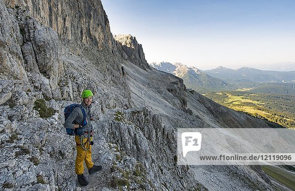Hiker on the way to Santner via ferrata  Rosengarten Group  Dolomites  South Tyrol  Trentino-Alto Adige  Italy  Europe