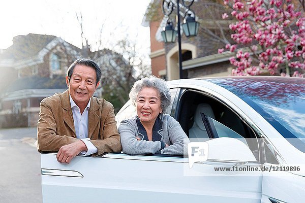 The old couple stood by the car