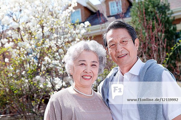 The elderly couple are outdoors