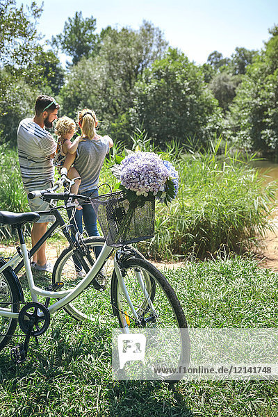Family with bicycle in the countryside