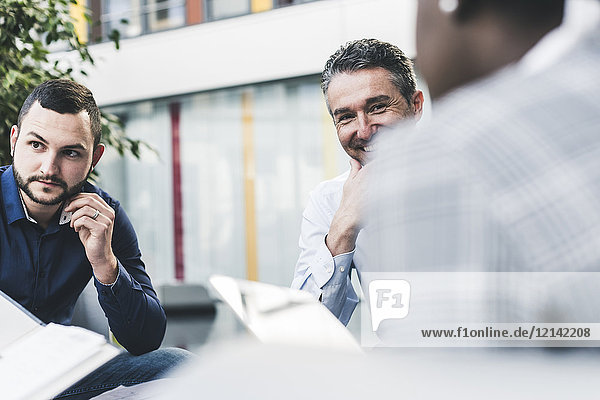 Smiling businessman having a meeting with colleagues