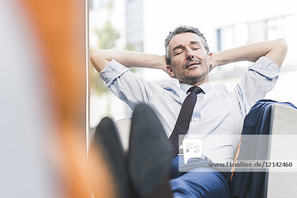 Portrait of businessman relaxing in lounge