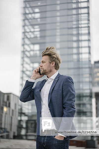 Businessman on cell phone in the city