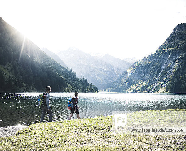 Austria  Tyrol  young couple hiking at mountain lake