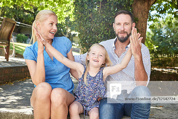 Porträt einer glücklichen Familie im Garten